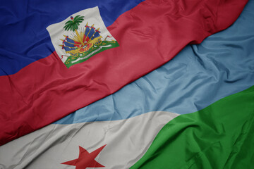 waving colorful flag of djibouti and national flag of haiti.