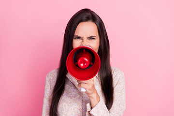 Closeup photo of young funny agressive woman hold loudspeaker talk hate words you isolated on pink...
