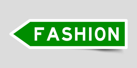 Green color arrow shape sticker label with word fashion on gray background