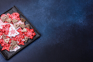 Christmas decorations and gingerbreads on a dark concrete table. Getting ready to celebration