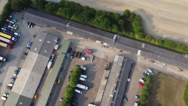 British Agricultural and Harvesting Fields Farms at Sunset Time. High Angle Footage taken with drone's camera on a hot summer day of England. Agricultural Farms and Working Machines at Dunstable Downs