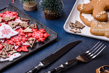 Christmas decorations and gingerbreads on a dark concrete table. Getting ready to celebration