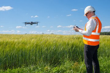 Geodetic quadrocopter. Man surveyor. Quadcopter launch over field. Surveyor launches drone....