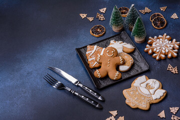 Christmas decorations and gingerbreads on a dark concrete table. Getting ready to celebration