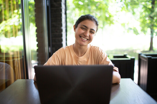 Indian business blogger vlogger woman working on her laptop outdoor
