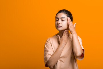 Close up portrait of young indian american woman doing facebuilding yoga face gymnastics yoga self...