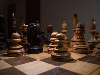 Vintage wooden chess on a chessboard, close-up. Intellectual game, strategic calculation, concept
