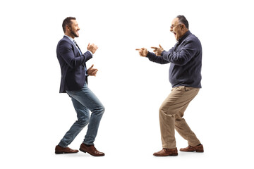 Full length profile shot of a young professional man dancing with a mature man