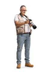 Full length shot of a mature male photographer looking at a camera display