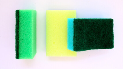 multi-colored foam rubber sponges for washing dishes close-up on a white background