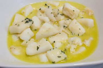 Close-up of a delicious plate with cuttlefish in garlic sauce. Easy and healthy recipes.