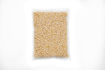 Peeled Pine Nut In Transparent Vacuum Big Plastic Packaging On White Background.