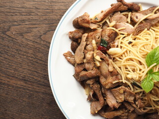 Top view grilled pork meat with spaghetti on wood