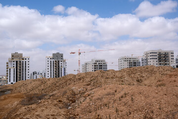 Construction site, several houses are being built, group of unfinished residential complex.