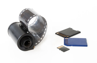 Micro SD card against vintage roll film in reel, on white background