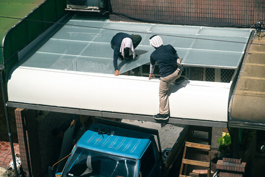 Workers working hard on the roof