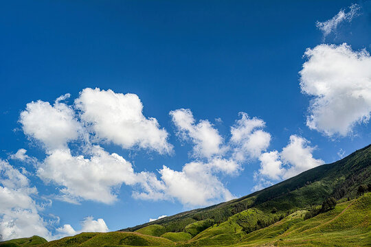 blue sky white cloud comulus above green hill. Bromo Tengger semeru national park. mountain 