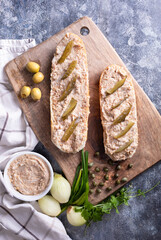 Rustic composition with rillettes, spread meat product. Sandwiches with rillettes, meat pate on a wooden cutting board. - obrazy, fototapety, plakaty