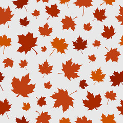 Obraz premium Halloween seamless pattern made up of many orange maple leaves on the black background for printing on wrapper, package, cloth, textile or cards. Endless repeating texture for autumn holidays.