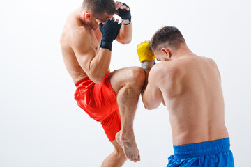 Two men boxers fighting muay thai kick boxing white background