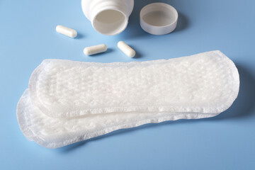 Women's sanitary napkins for the menstrual period with a can of pill for menstrual pain