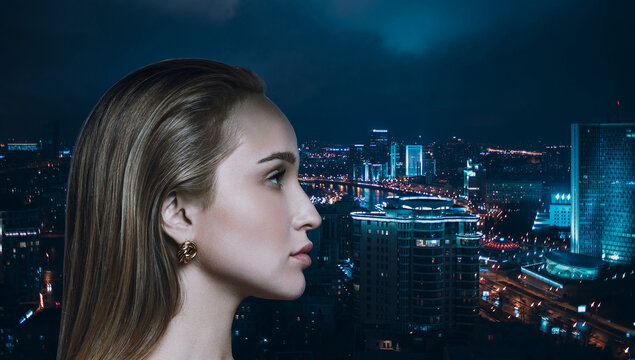 Young caucasian woman beauty profile portrait in sari on night cityscape background.