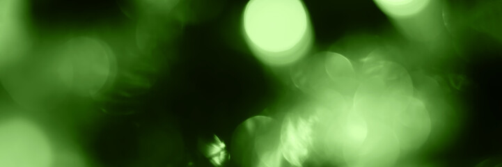 Blurred lights, green background, banner texture. Abstract bokeh with soft light header. Wide...