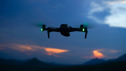 Fototapeta na wymiar Silhouette of a drone during the sunset or sunrise, unmanned aerial vehicle in the outdoor