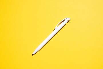 white pen in the center on a yellow background