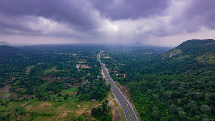 Fototapeta na wymiar Aerial view of road going through greenery, Roads through the green forest, drone landscape