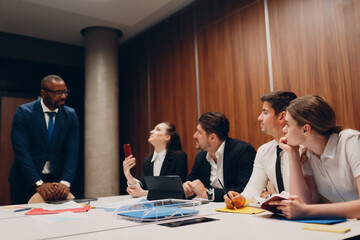 Businessman and businesswoman team at office meeting. Business people group conference discussion sit at table with boss man and woman