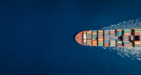 Aerial top down view of a large container cargo ship in motion over open ocean with copy space - obrazy, fototapety, plakaty