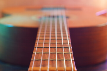 Fototapeta premium Selective soft focus guitar close up. Vintage filter, neon lights
