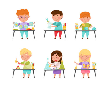 Happy cute little boys and girls painting and cutting paper crafts at lesson set cartoon vector illustration