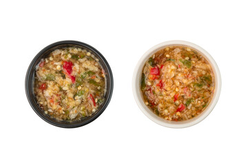 Close up Thai spicy seafood dipping sauce in white bowl and black bowl isolated on white background.Top view