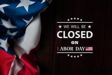 Labor Day Background Design. American flag on a wooden table with a message. We will be Closed on...