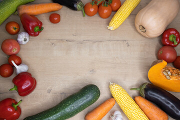 Top view frame with fresh organic vegetables on wooden background place for text mocap copy space. Concept: healthy or vegetarian food, proper nutrition, diet, nutritionist. Happy Thanksgiving