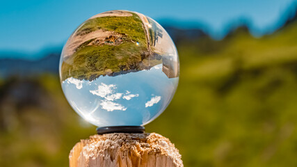 Crystal ball alpine landscape shot at the famous Hahnenkamm summit, Reutte, Tyrol, Austria