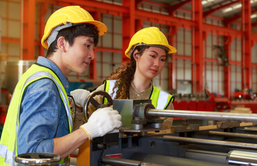 Asian male and female engineers team Control, check, maintenance of machinery. sheet metal fabrication