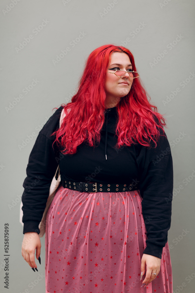 Wall mural Plus size overweight fat body positive lgbtq woman with red hair and pink glasses.