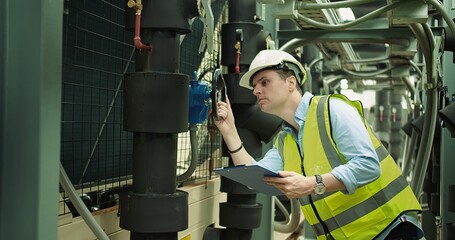 Portrait Professional Inspector Engineer foreman in hardhat working checking the valve pipelines...