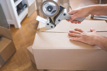 moving house - close up of a hand holding a cardboard box