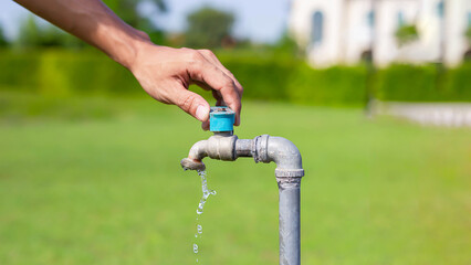 Old faucet outside the house dripping