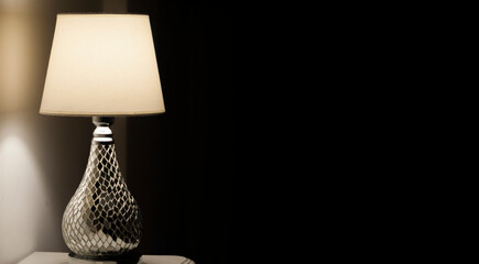 Modern illuminated lamp inside a house. Copy space.