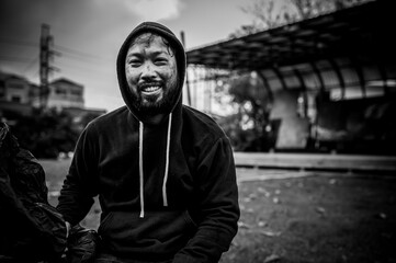 Asian man is homeless at the side road,A stranger has to live on the road alone because he has no family.