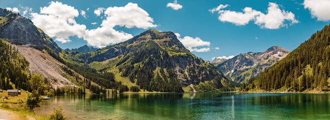 High resolution stitched panorama with reflections at the famous Vilsalpsee, Tannheimer Tal valley,...