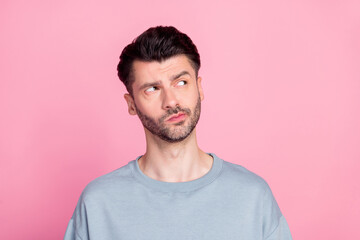 Photo of minded serious person look interested empty space hesitate isolated on pink color...
