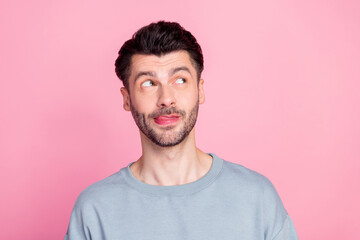 Photo of minded positive person tongue lick lip look interested empty space isolated on pink color background