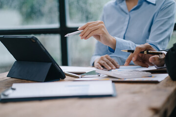 Group of business people meeting together Pointing to the graph assess business profits