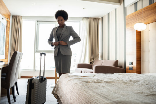 African-American businesswoman checking out from the hotel room after all day discussing and talking at the conventions and seminars.